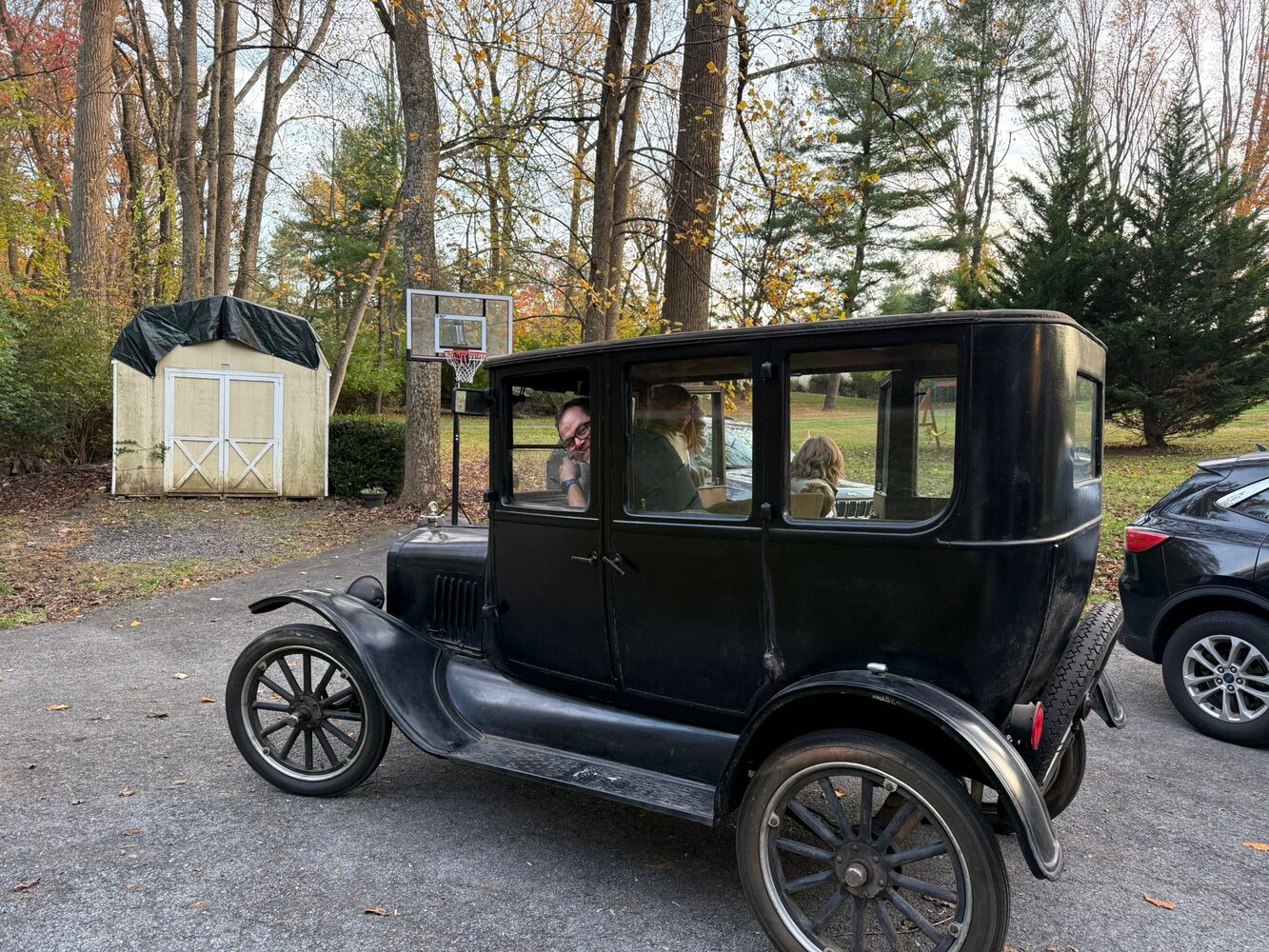 The family riding in Curly, photographed from the side at home